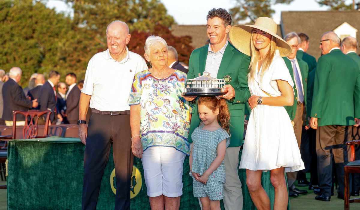 Rory McIlroy of Northern Ireland holds the trophy wearing his Green Jacket with his family. PIC: David Cannon/Getty Images