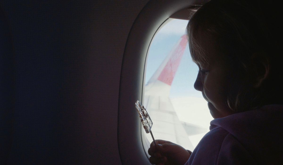 Girl with lollipop on plane