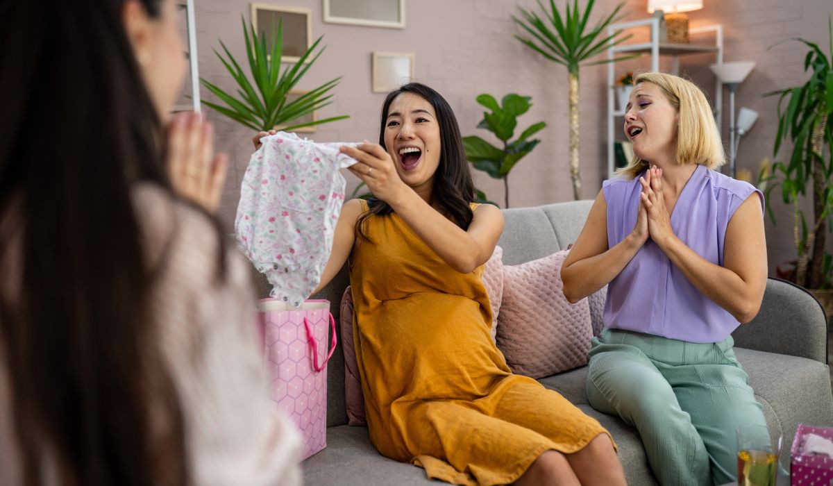 Pregnant woman getting gift at baby shower