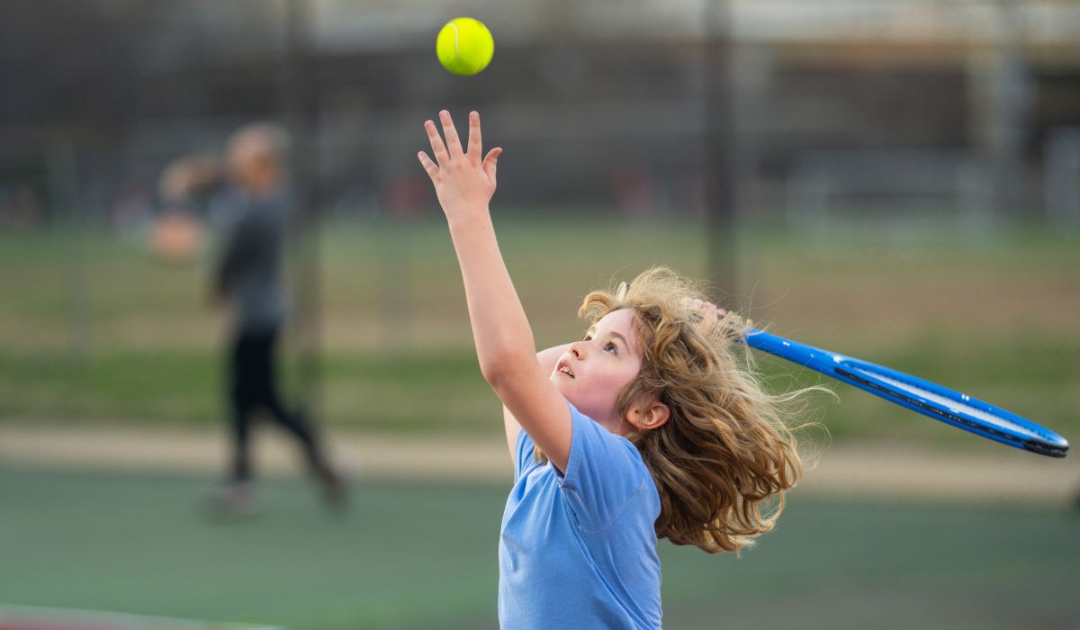 Child playing tennis