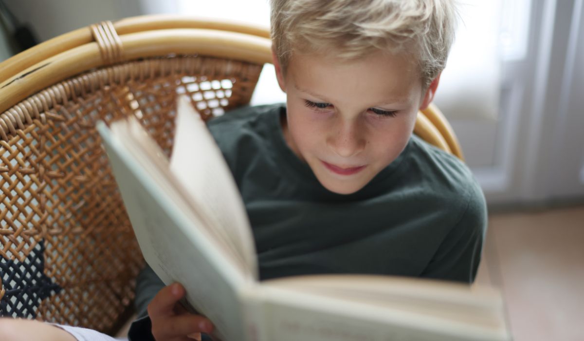 Young boy reading book