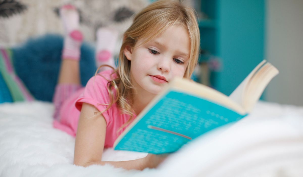Little girl reading book