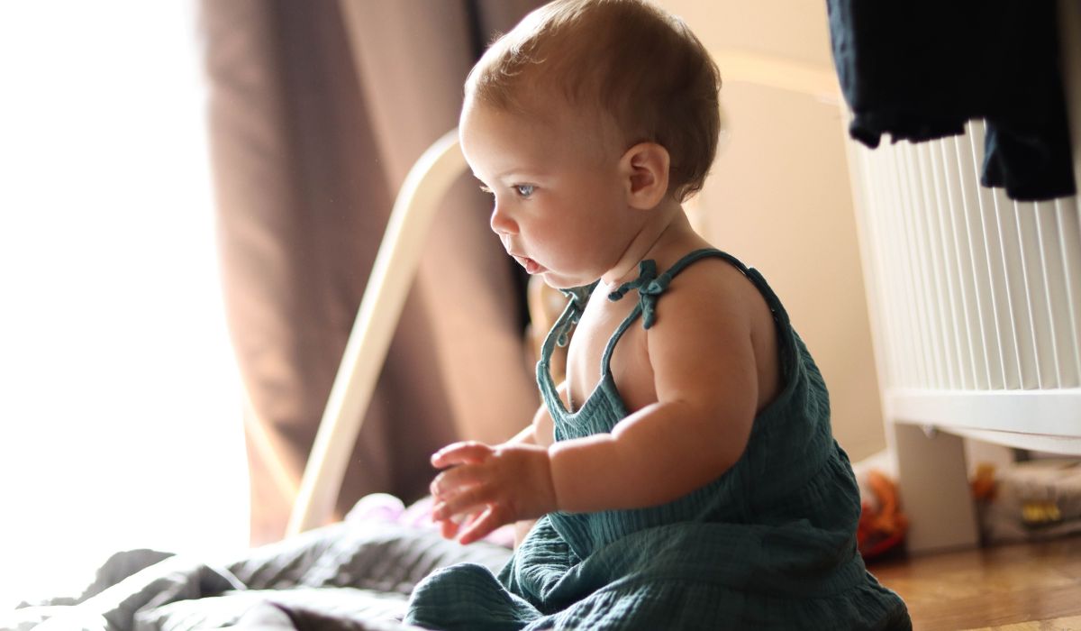 Baby sitting on bed