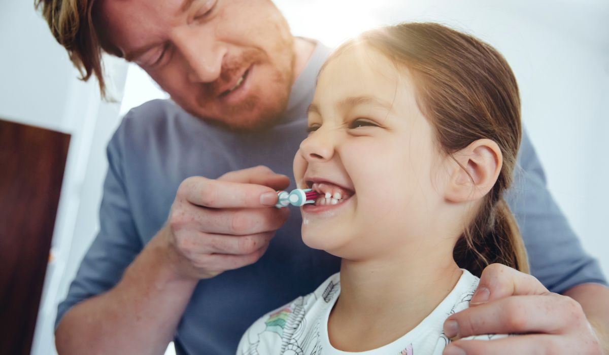 Dad brushing daughter's teeth