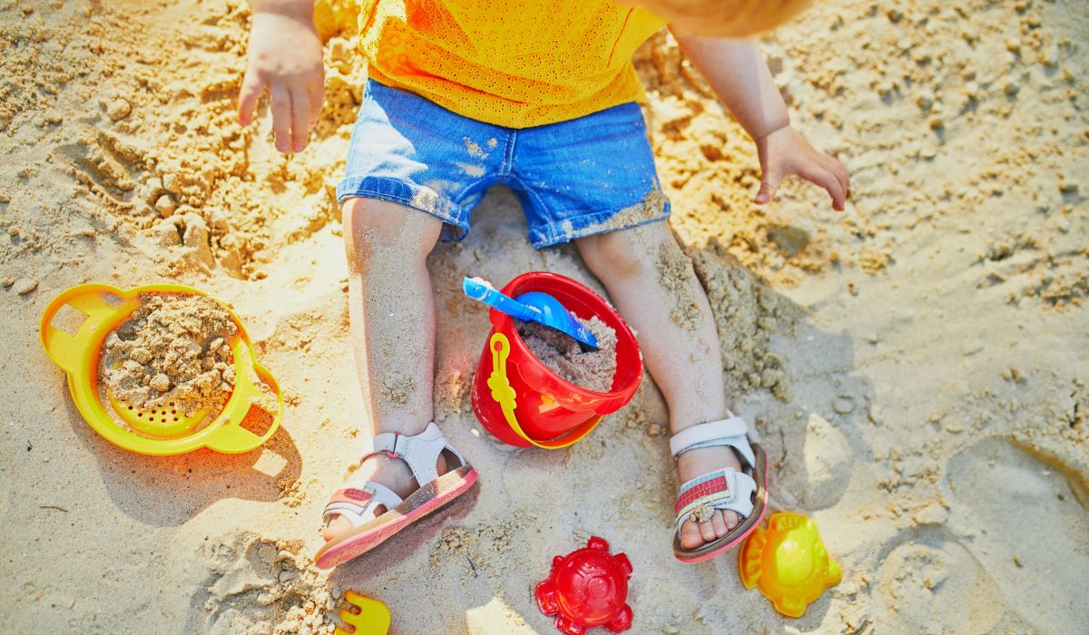 Child playing in sand pit