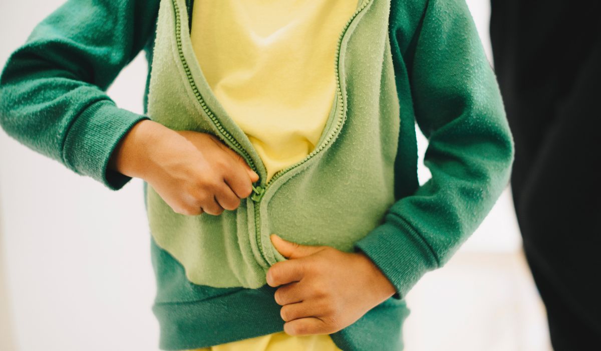 Child zipping up jacket