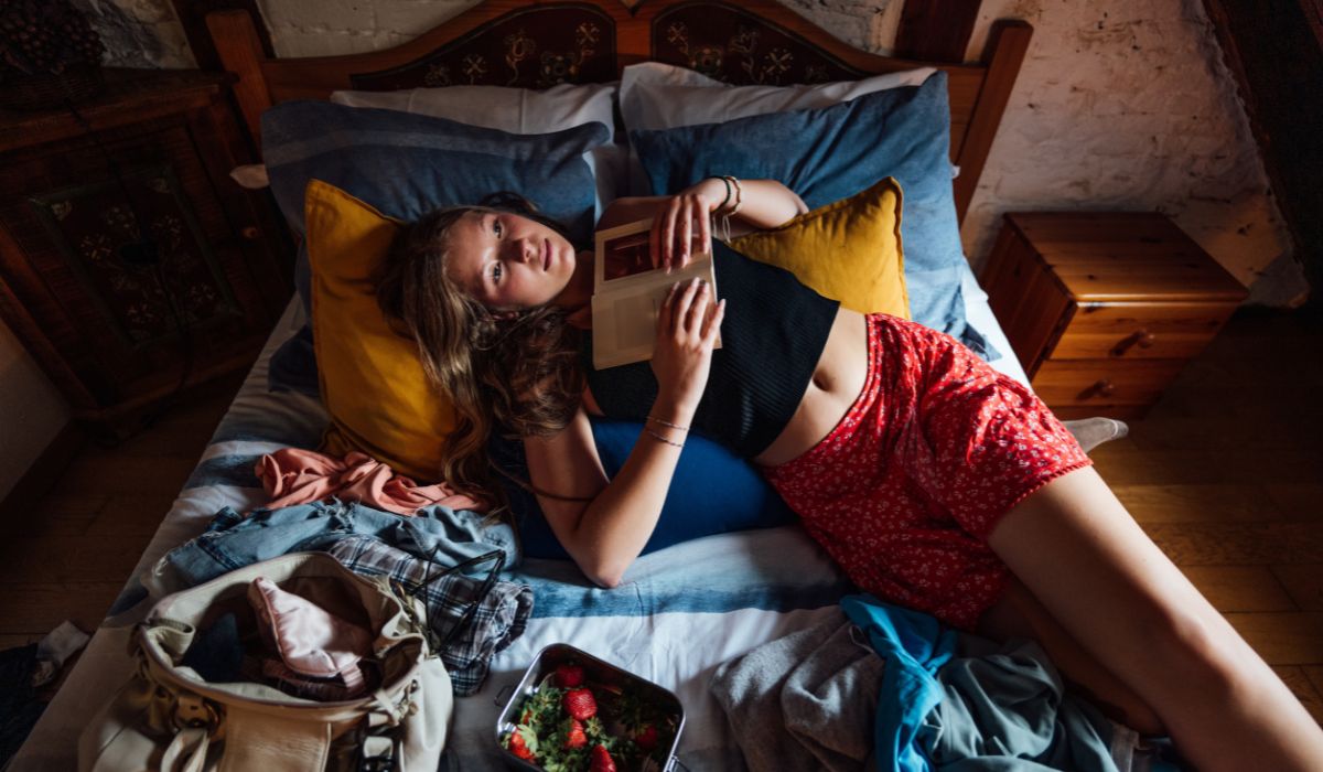 Teen in bed with book
