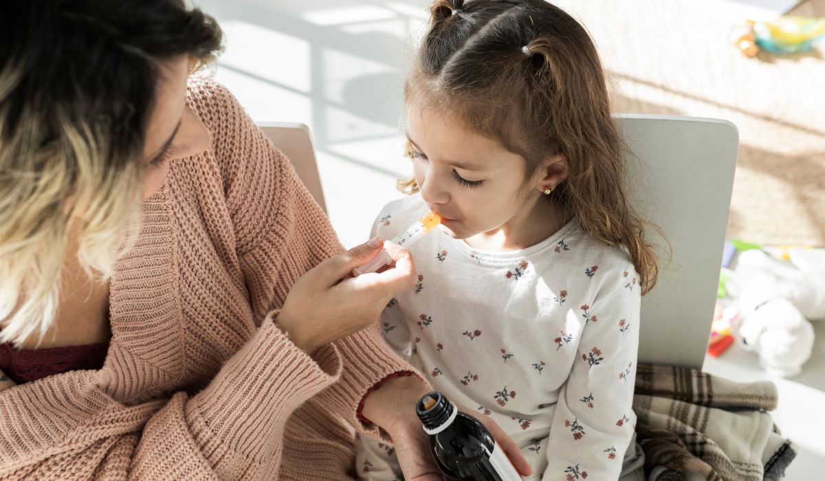 Mother giving child medicine