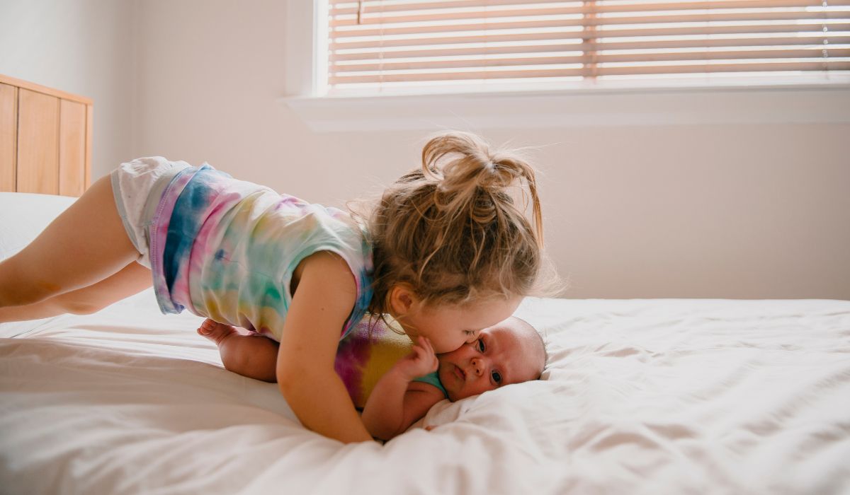 Siblings on bed