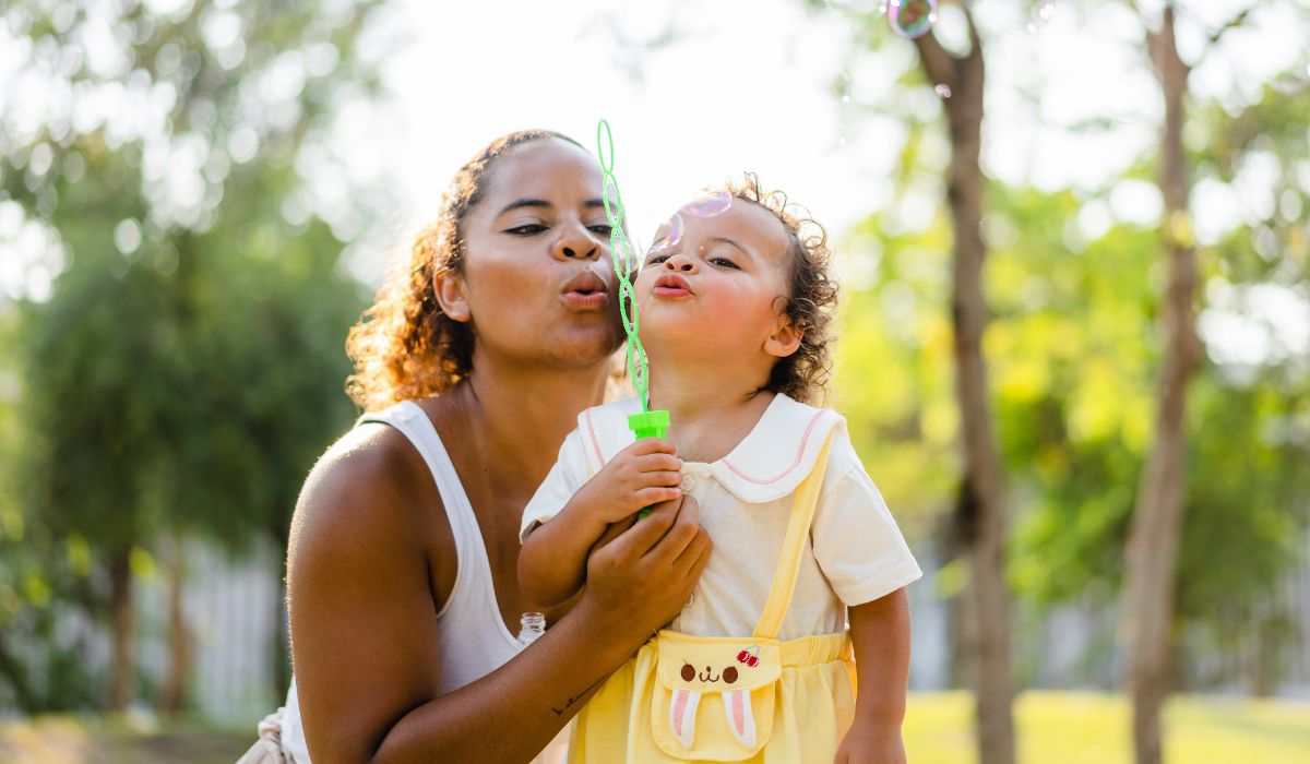 Mother and child blowing bubbles