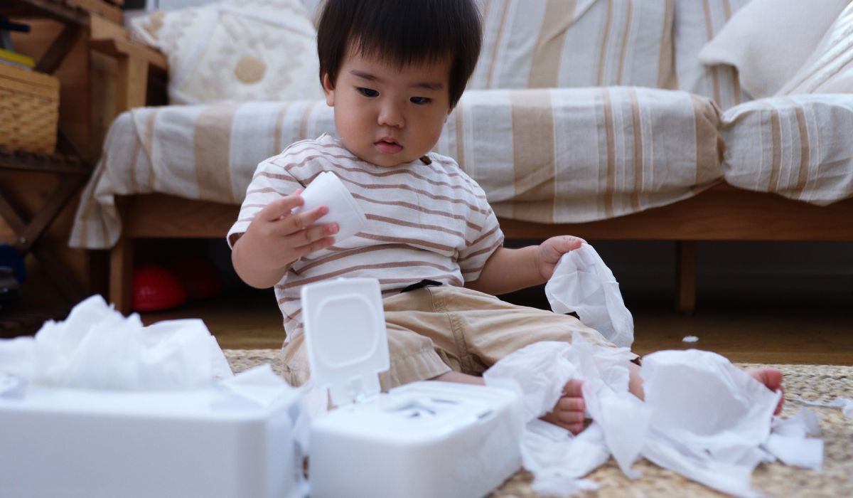 Baby playing with wipes