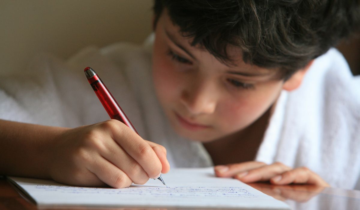 Boy writing in school