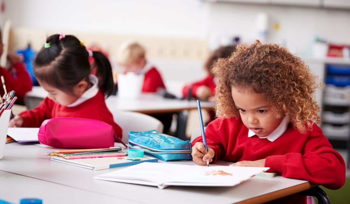 Children writing in classroom