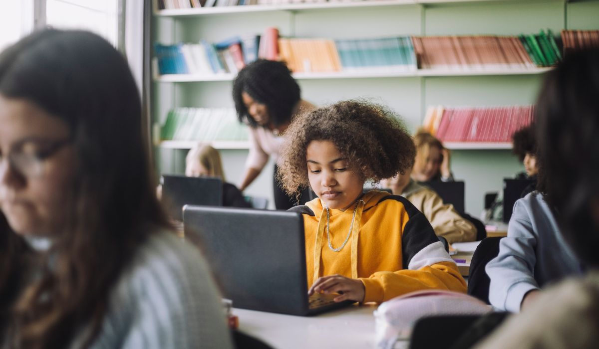 Girl using laptop in class