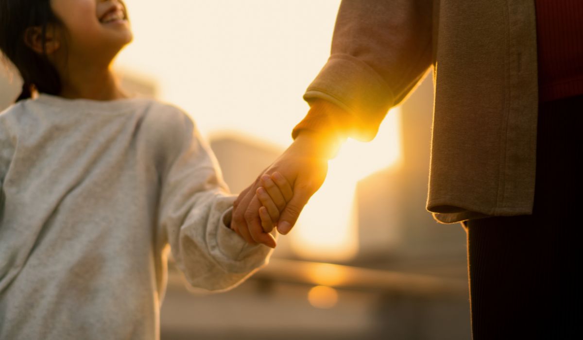 Mother holding child's hand