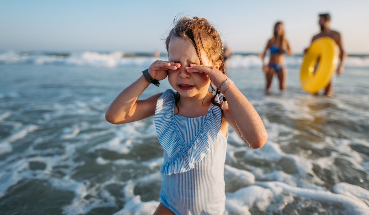 little girl crying on the beach