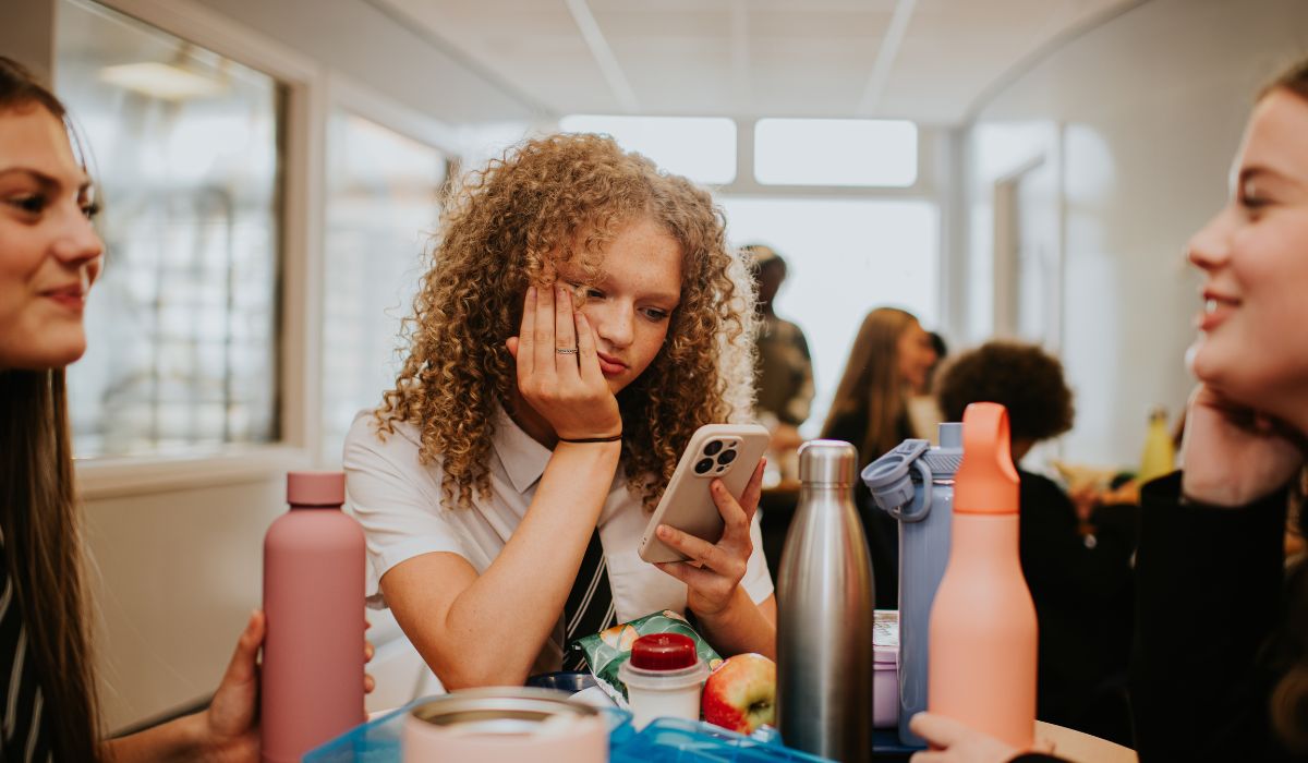 Secondary school girl looking at phone