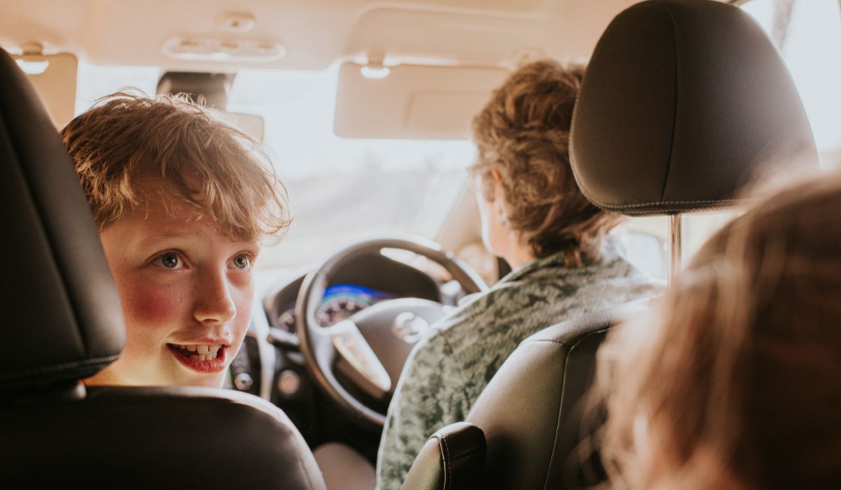Child sitting in front seat of car