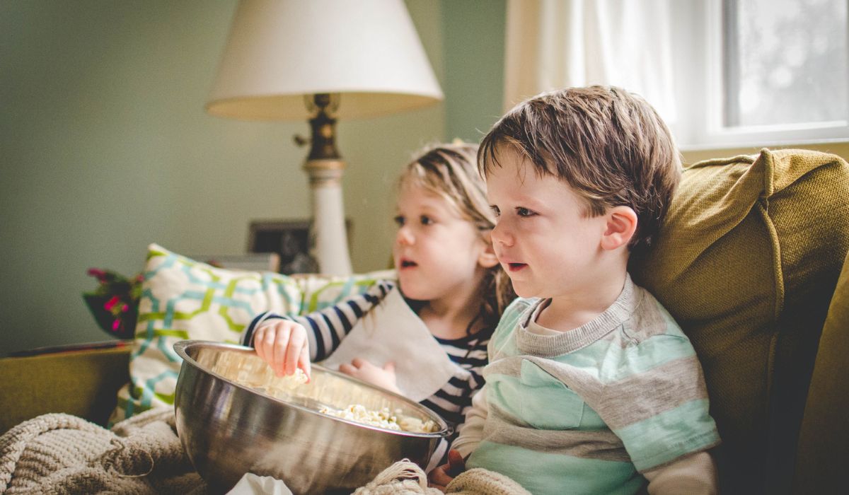 Two little boys watching a TV show