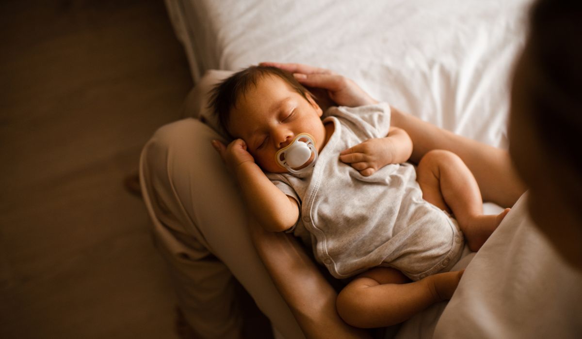 Baby sleeping on mother's lap