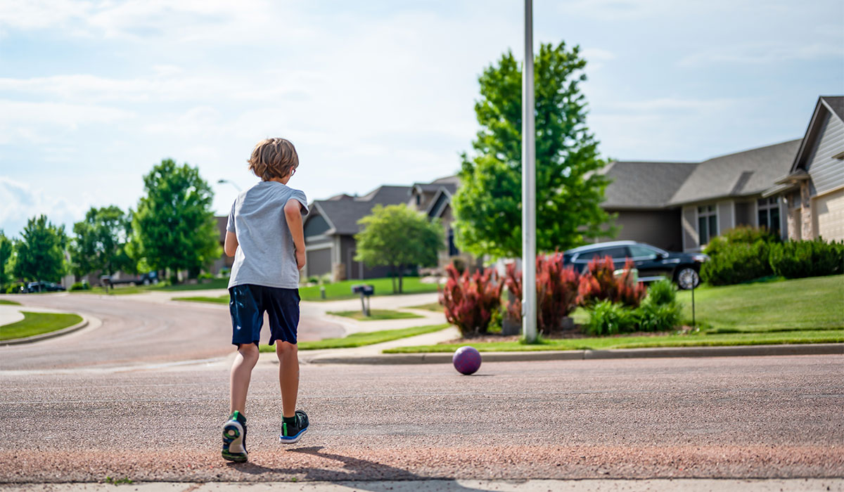 Chasing a ball that has crossed the street by rolling into a road.; Shutterstock ID 2317534425; purchase_order: -; job: -; client: -; other: