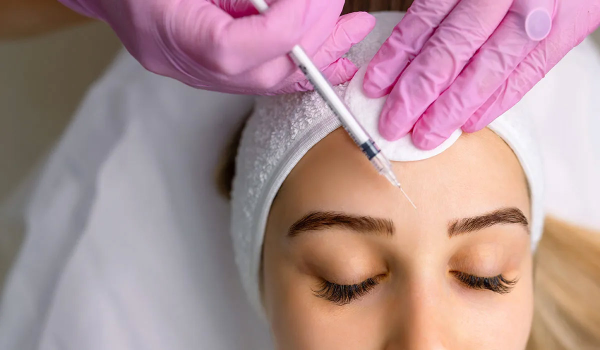 Woman getting botox with long eyelashes, botox in a bottle