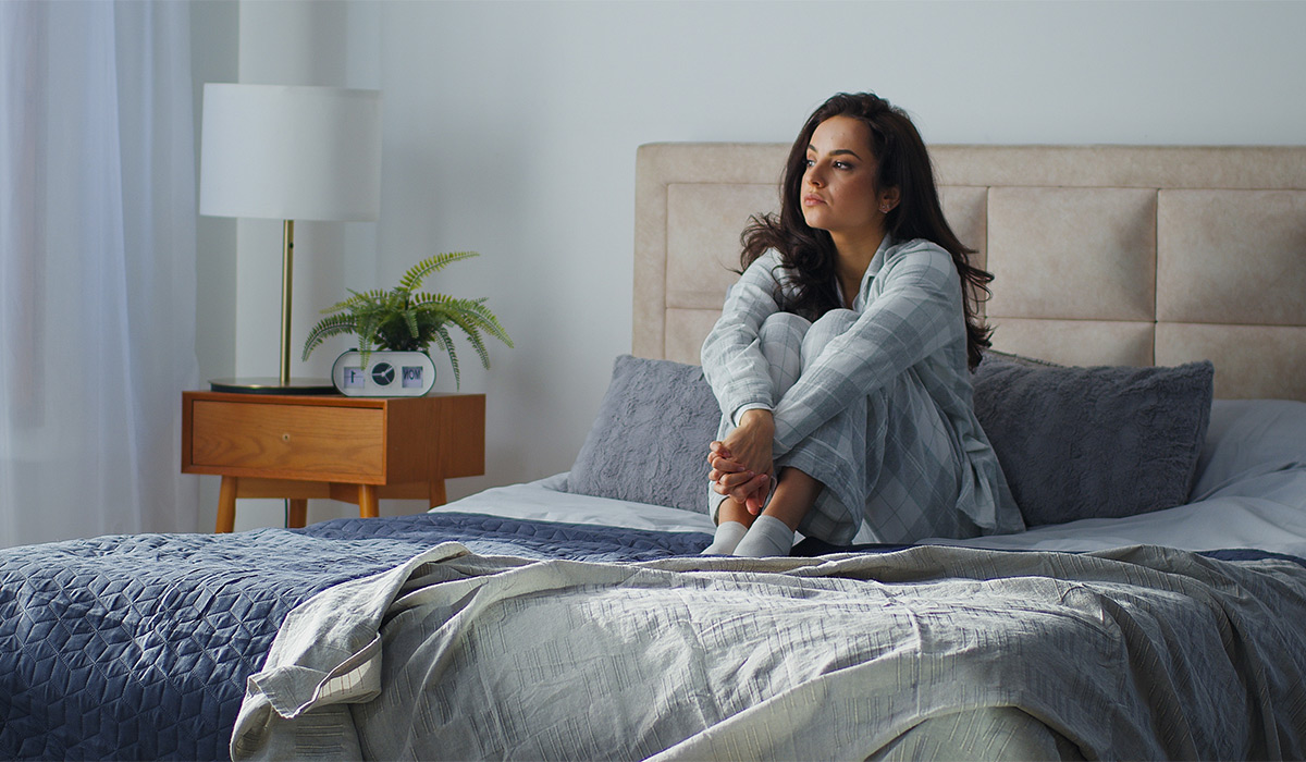 Caucasian pensive dreamy woman sitting on comfortable bed in cozy bedroom home thoughtful girl female think dreaming lady thinking dream calm peace waking up in morning mental melancholy tranquil mood; Shutterstock ID 2724432339; purchase_order: -; job: -; client: -; other: