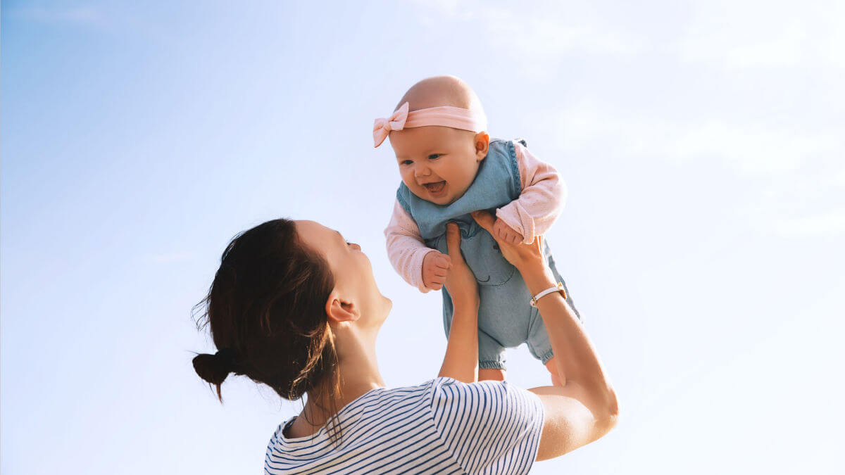 Mum holding baby up in the air